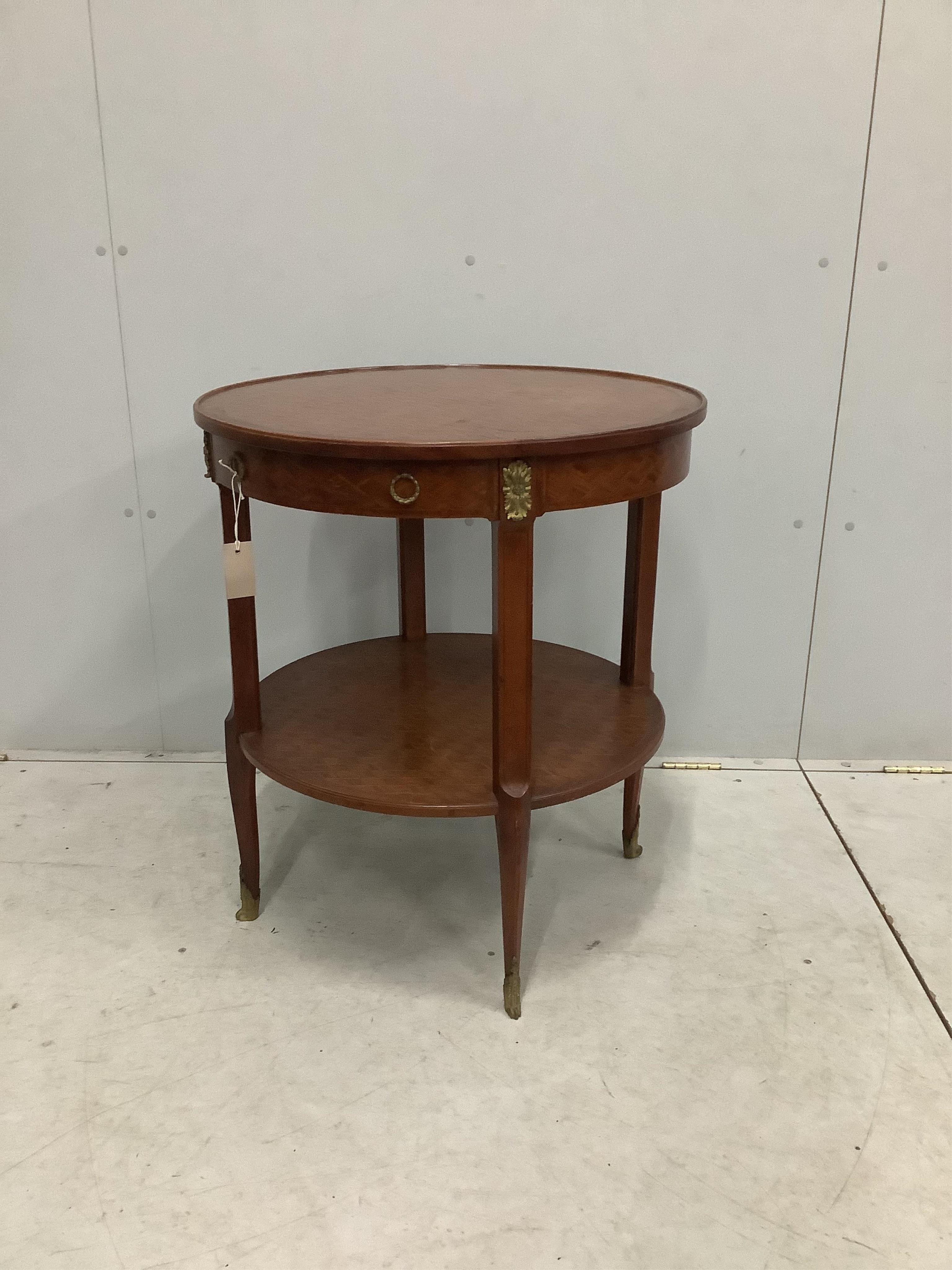 A French transitional style gilt metal mounted circular two tier occasional table, diameter 66cm, height 75cm. Condition - fair